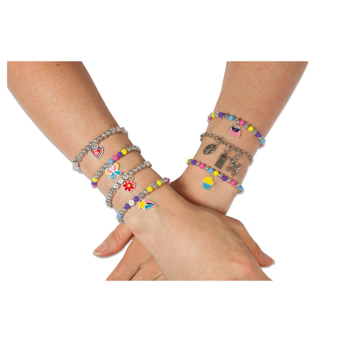 Arms and wrists wearing Jewellery charm bracelets 