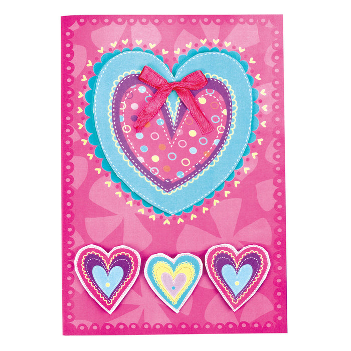 Card Craft with pink card and heart shaped stickers and a ribbon 