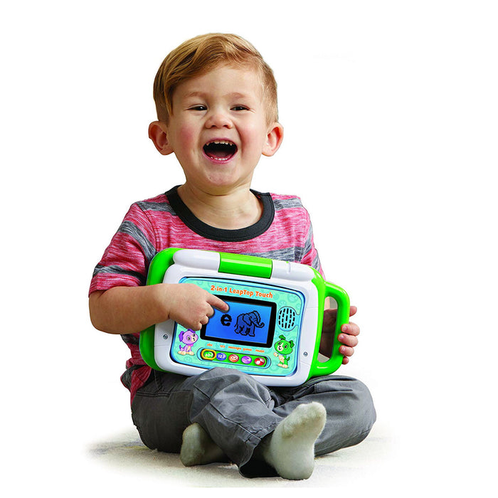Child playing with Leapfrog Laptop in the colour green 